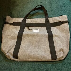 Journeyman grey duffle bag with red striped interior
